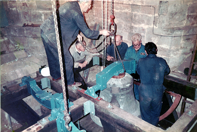 Bell attached to the headstock being fitted on to the frame