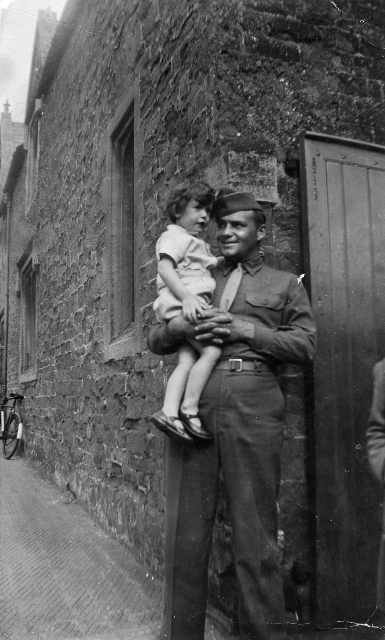 A young Clive Sanders 1944 being held by American Jim Cole