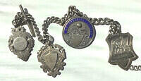 Football match winning medals on watch chain