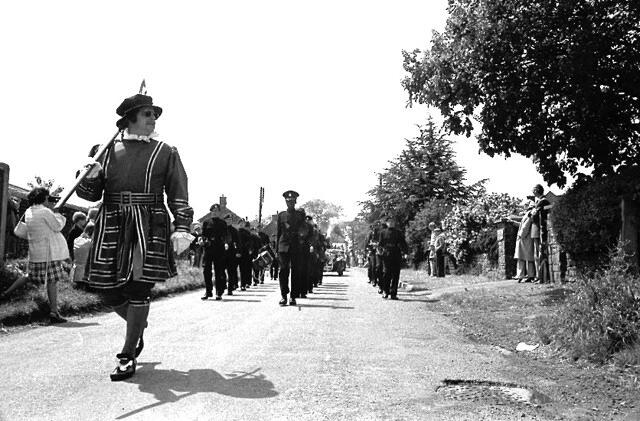 Our local Beefeater, Eric Kimble, leads the parade of floats on Jubilee Day