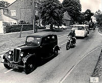 Len Plumbe in his Morris 8, Mike and Karen O'Neill on Mike's vintage motorcycle behind