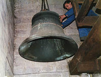 Bell being lifted by pulley up to the belfry through a trapdoor in the floors