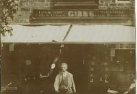 Joshua Gibbs (b.1835) in front of shop