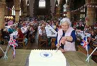 Deddington resident Jane Kellett, whose 90th birthday was very close to that of the Queen, cuts the cake