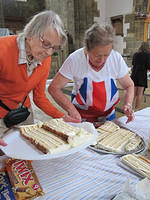 Ruth Johnson and Bryony cutting the cake to share among visitors