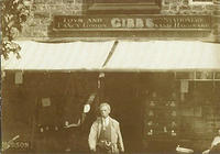 Joshua Gibbs in front of his shop, c.1900